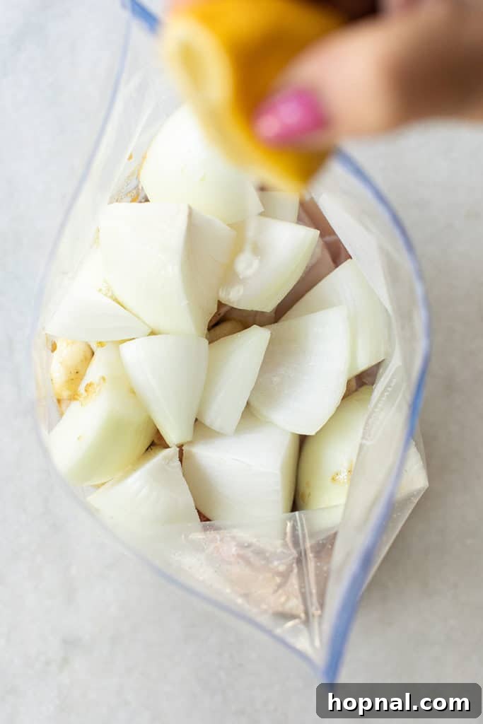 Lemon slices and quartered apples ready for the sheet pan meal.