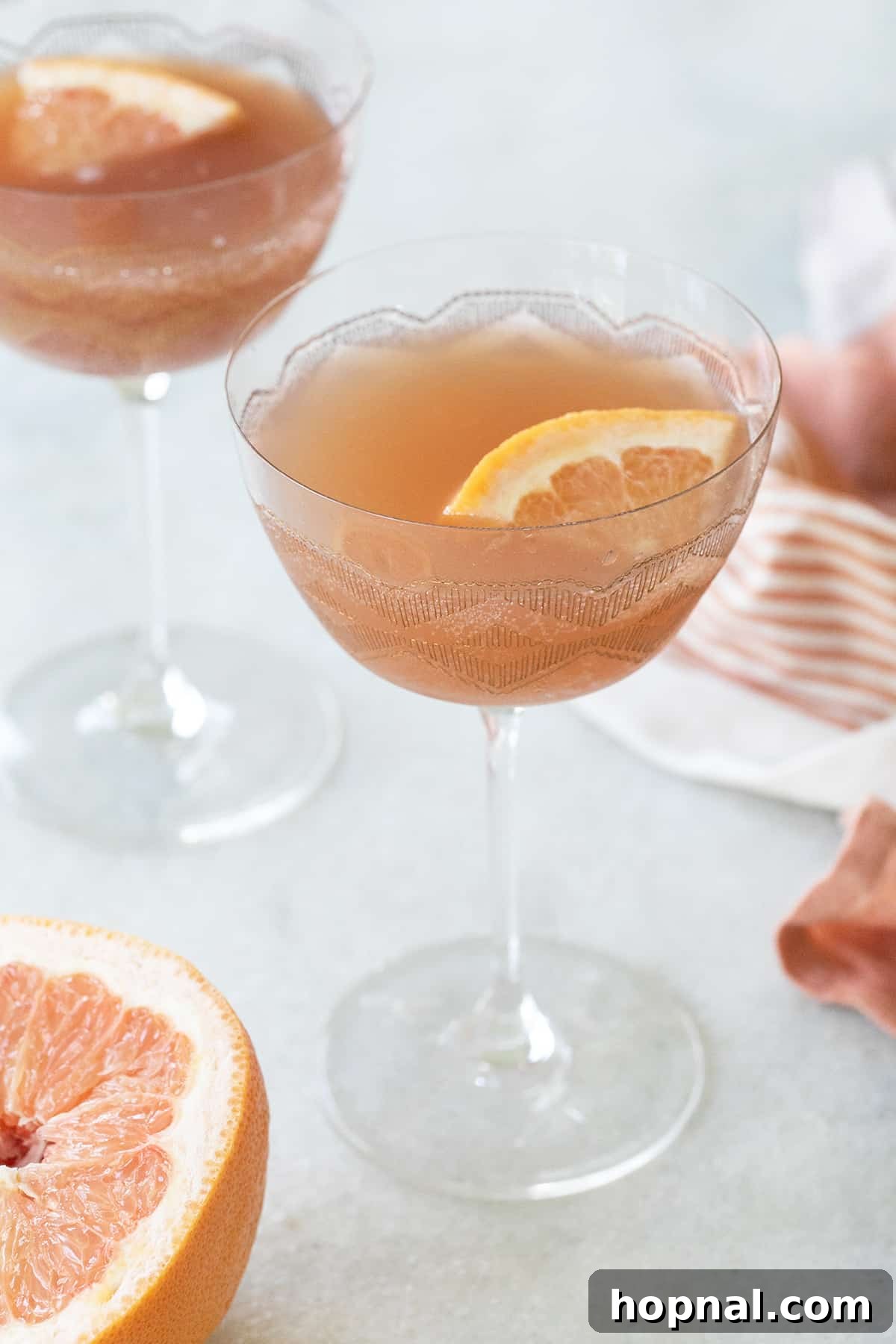 A vibrant Grapefruit Martini garnished with a fresh grapefruit wedge.