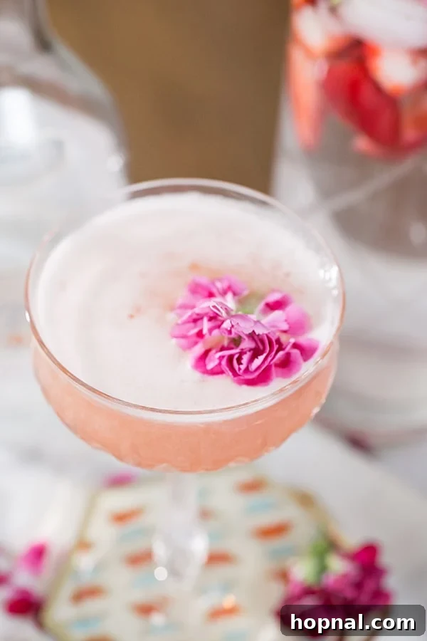A simple yet elegant Gin and Jam cocktail, beautifully adorned with a pink flower.