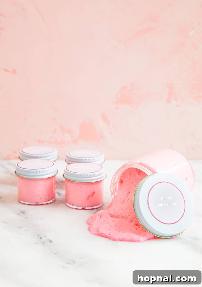 Heartfelt Creations: 14 DIY Valentine's Day Projects 15 Pink slime stored in small glass jars, adorned with a festive Valentine's Day printable label, captured by SHANNA SULLIVAN.