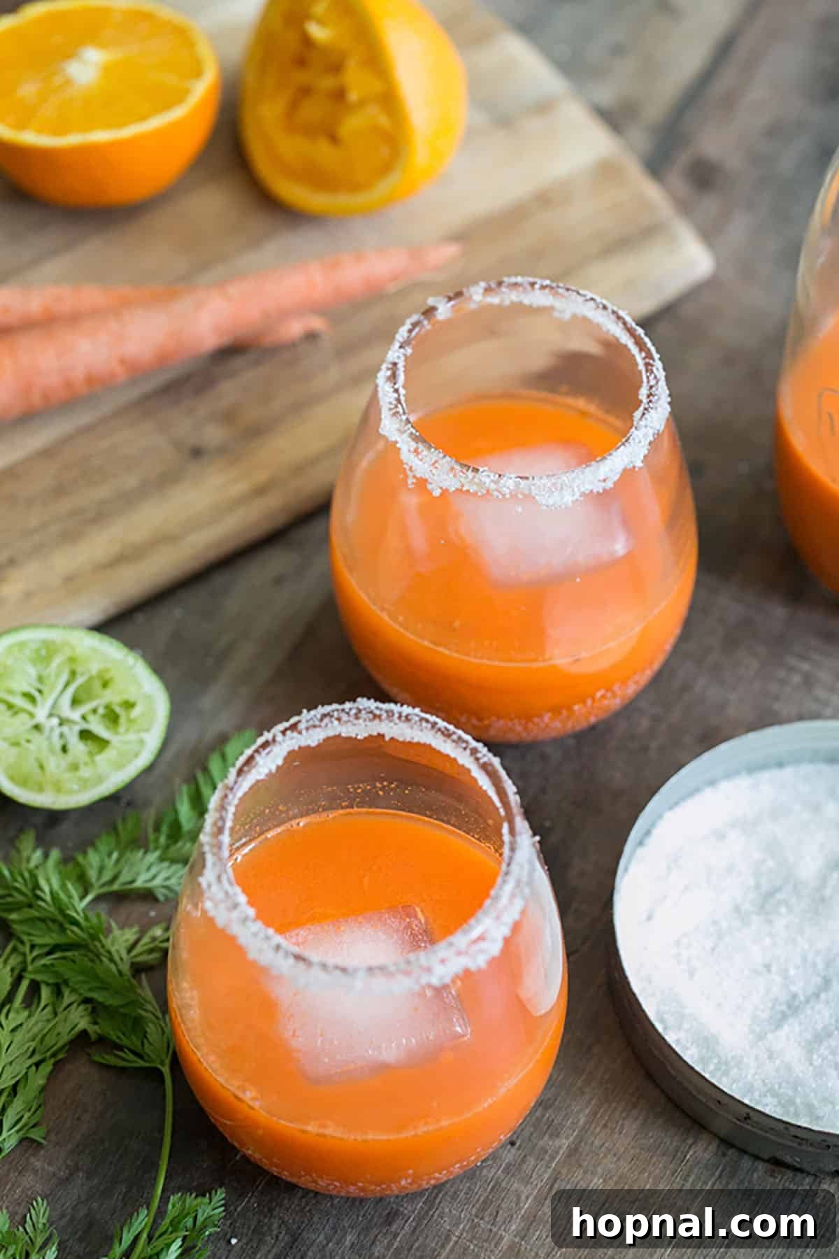 Margarita cocktail recipe with fresh carrot juice, garnished with a carrot curl.