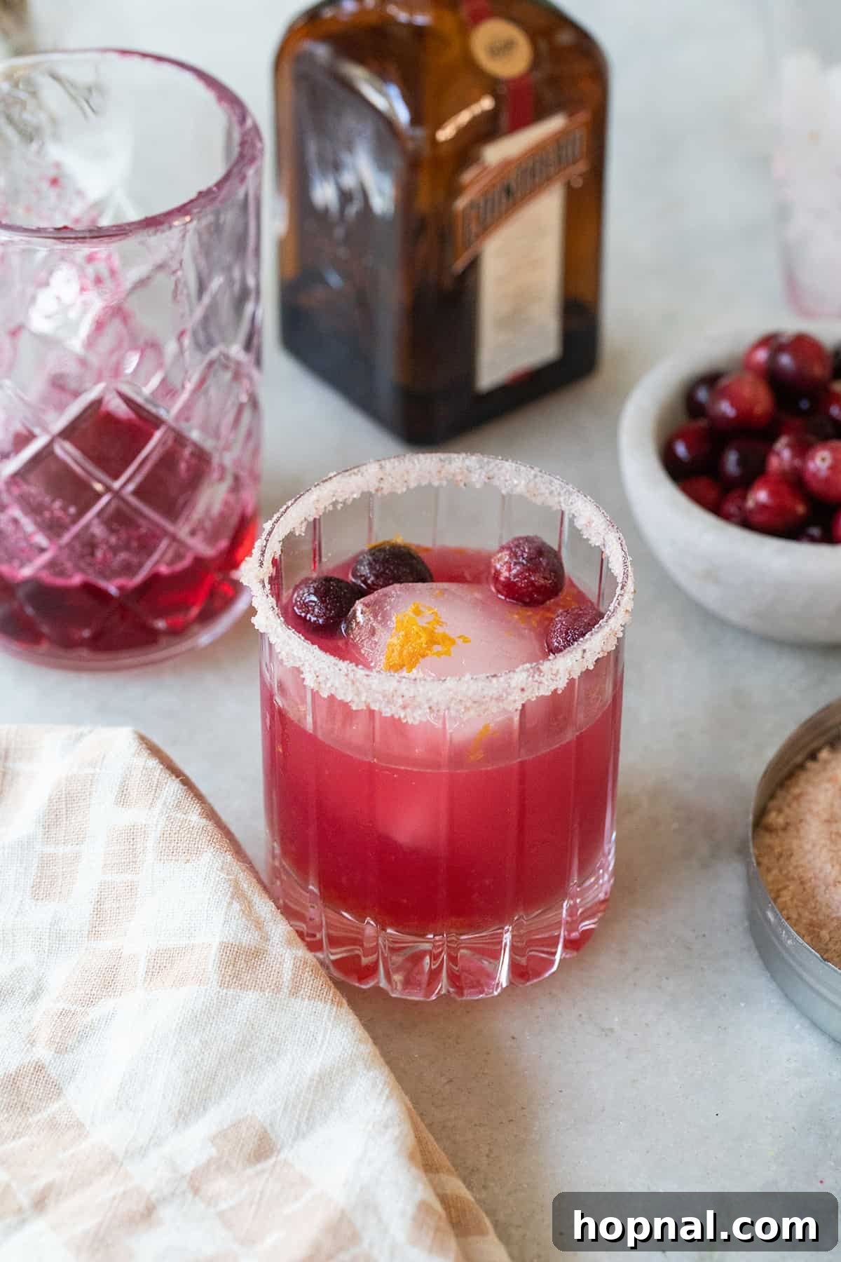 Cranberry margarita with a vibrant pink color and a salted rim, festive and tangy.