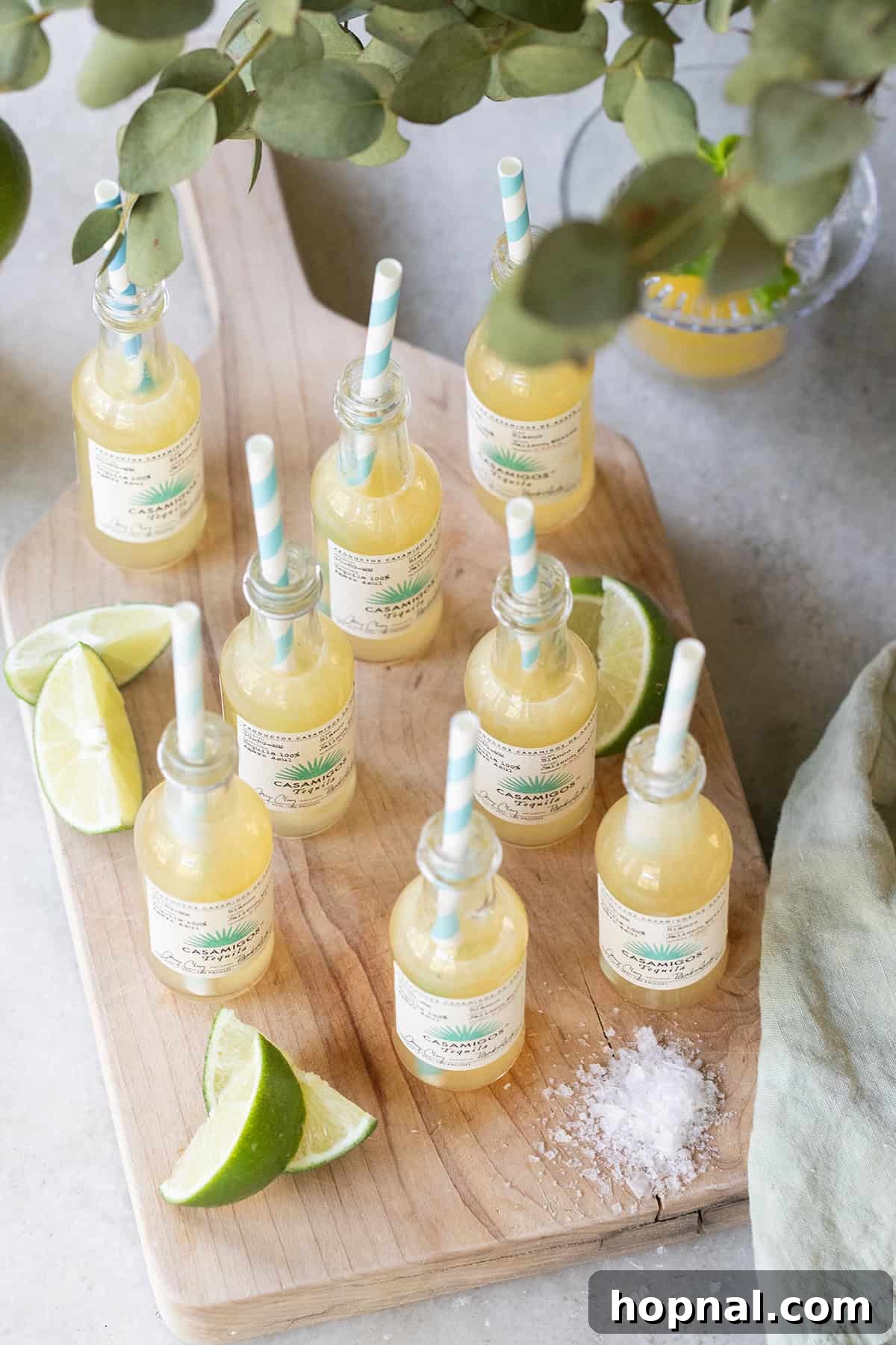 Margarita shots recipe served in mini tequila bottles for parties, a fun and unique presentation.