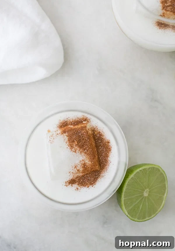 Three Ingredient Coconut Margarita, creamy white with a lime wedge.