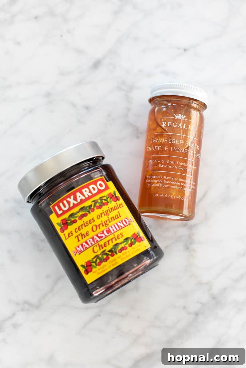 Valentine's Day Sweetheart's Grazing Board 13 Gourmet Luxardo cherries and a jar of premium Tennessee honey, presented alongside, hinting at luxurious additions to a dessert or charcuterie platter.