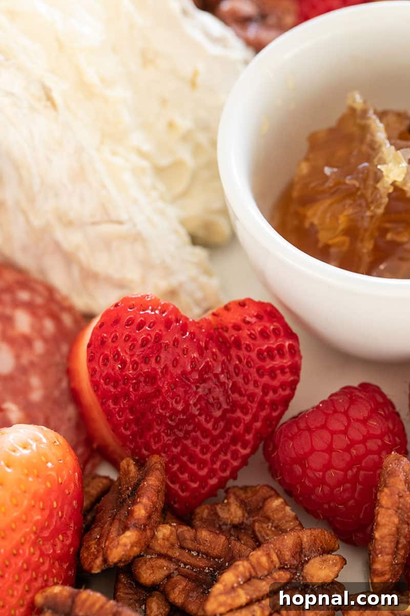 Valentine's Day Sweetheart's Grazing Board 15 A cluster of juicy, plump strawberries meticulously arranged into the shape of a heart, epitomizing a romantic and sweet gesture.