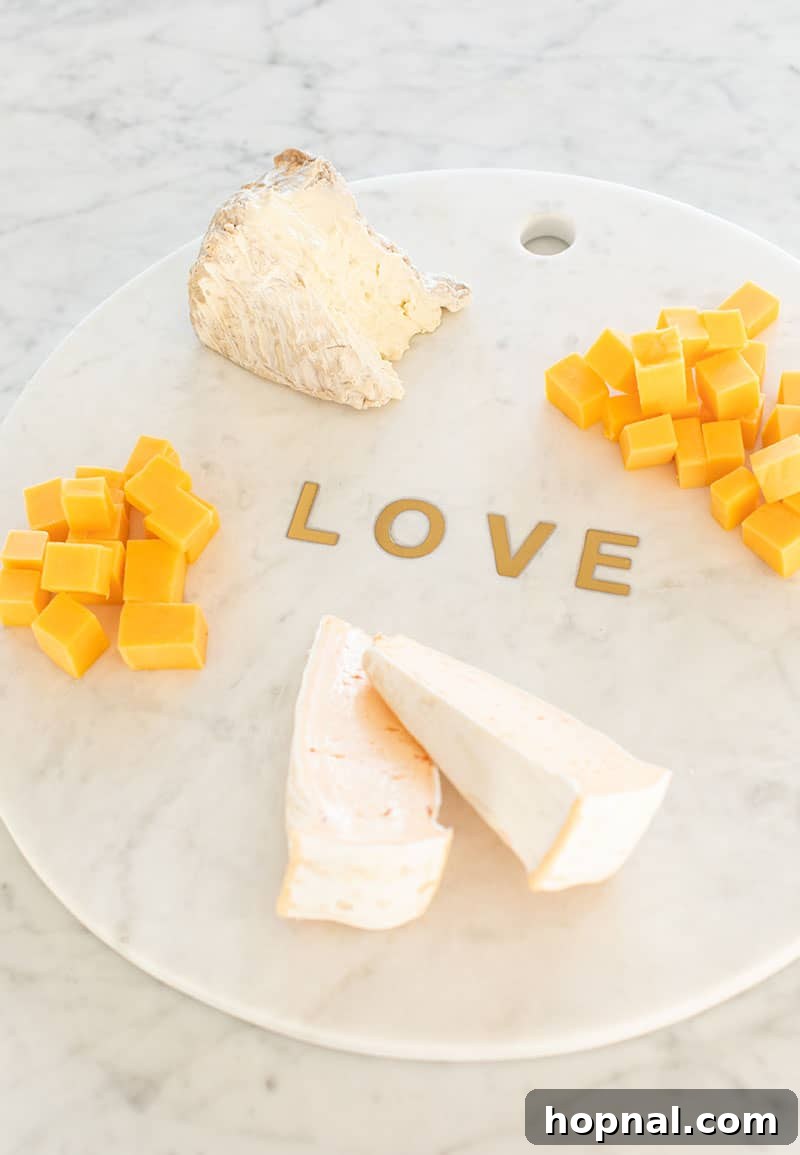 Valentine's Day Sweetheart's Grazing Board 9 A close-up of a perfectly arranged cheese on a luxurious marble platter, highlighting its texture and inviting presentation.