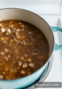 Green chilis, hominy and pork in a dutch oven