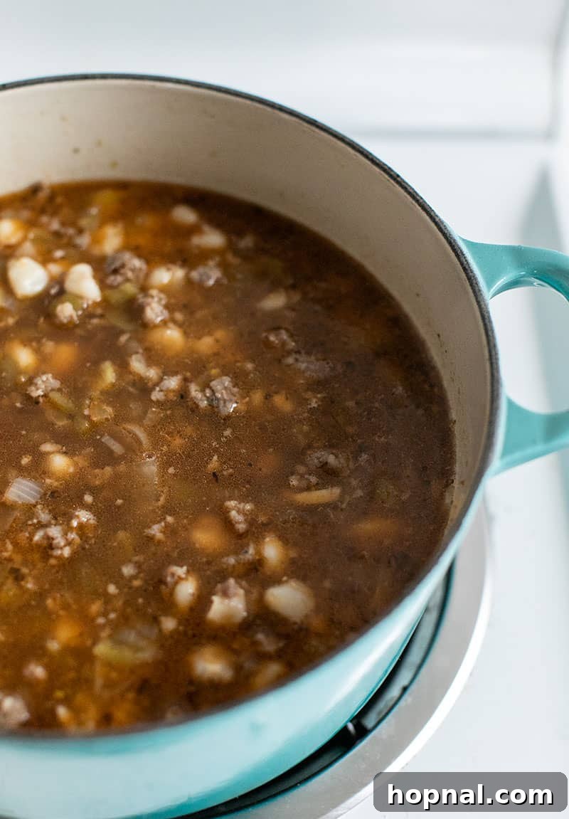 Hominy Soup The Ultimate Winter Comfort 10 The finished Pozole soup, simmering gently in the Dutch oven, its rich flavors fully developed and ready to be served.