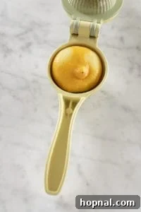 Fresh lemon being squeezed for juice, illustrating the importance of fresh ingredients for a lemon drop martini.