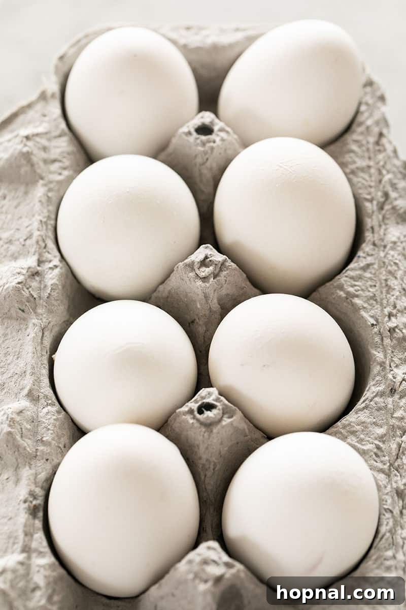 Mastering Easter Egg Dyeing and Design 6 White eggs in a carton.