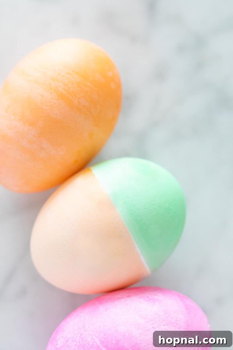 Mastering Easter Egg Dyeing and Design 8 Dying Easter eggs pink, green and orange.