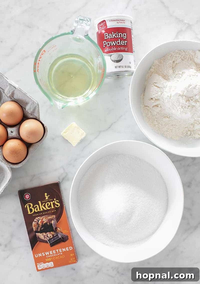 An array of high-quality ingredients laid out on a clean surface, essential for crafting rich homemade chocolate brownies: unsweetened chocolate, vegetable oil, granulated sugar, fresh eggs, unsalted butter, pure vanilla extract, and all-purpose flour.