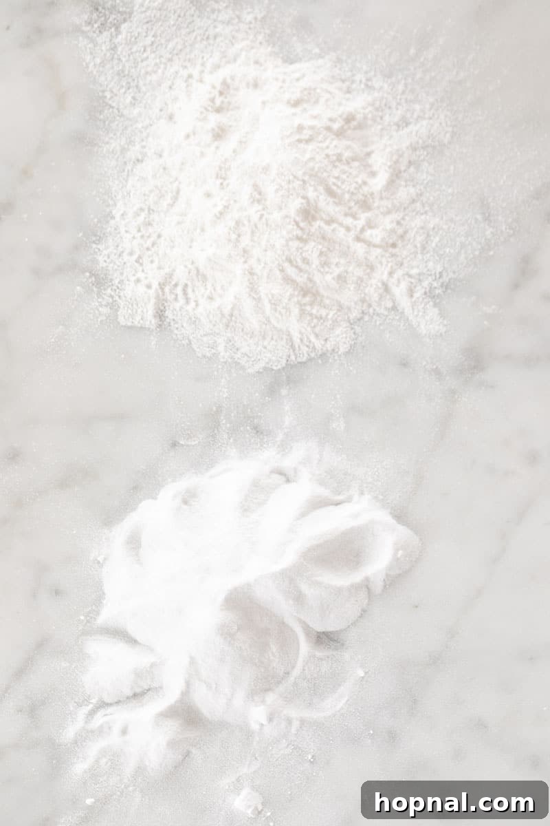 Baking soda and baking powder artfully arranged on a marble table.