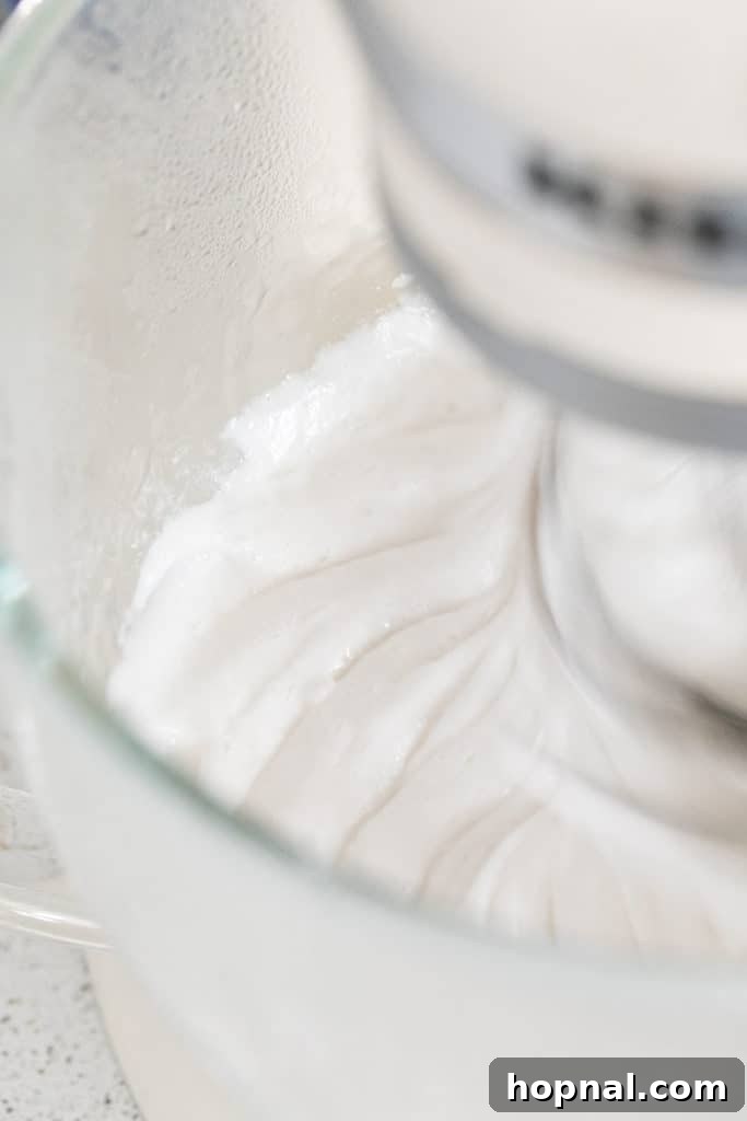 Rose Petal Clouds 9 Marshmallow mixture whipping in a stand mixer.