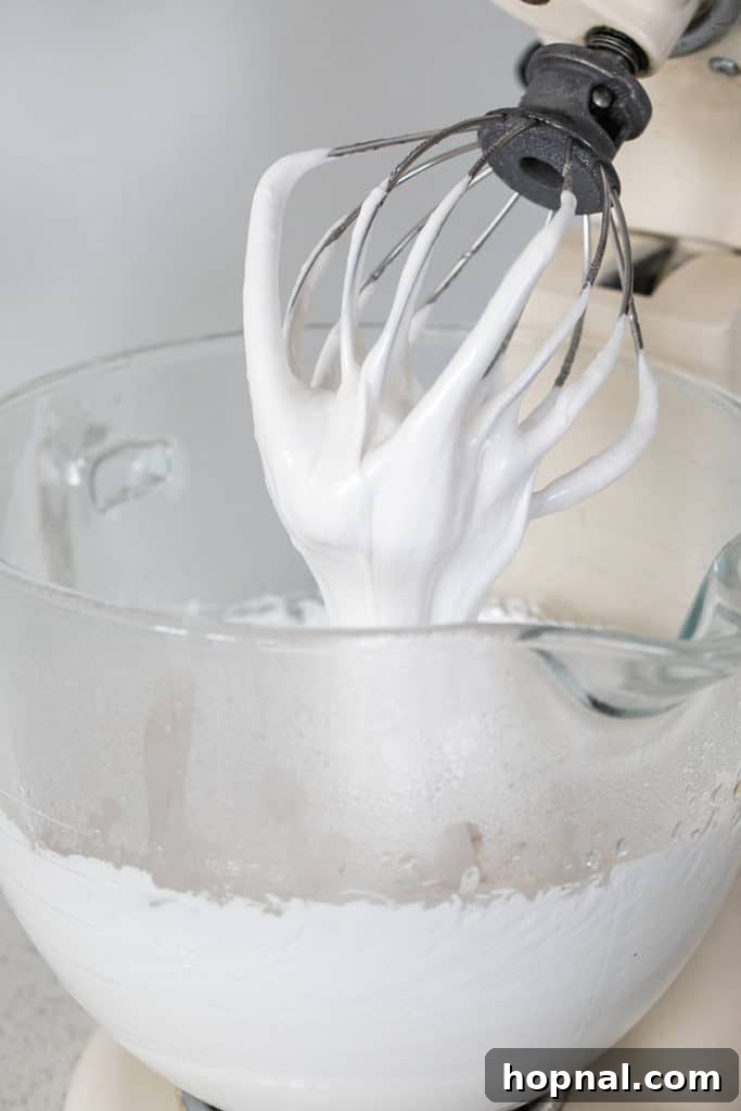 Rose Petal Clouds 10 Thick, fluffy marshmallow batter in a mixer.