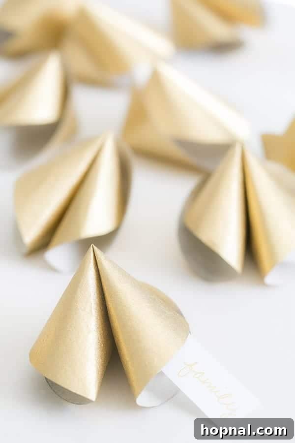 A collection of oversized, handcrafted paper fortune cookies, perfect for party decorations or interactive elements.