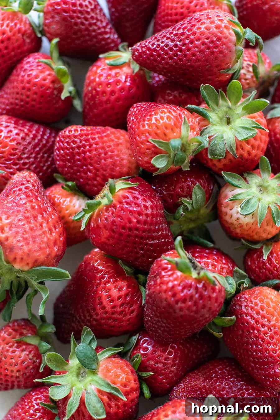 Whip Up Your Own Ice Pops 3 A close-up shot of fresh, ripe strawberries, gleaming and ready to be turned into delicious homemade fruit popsicles.