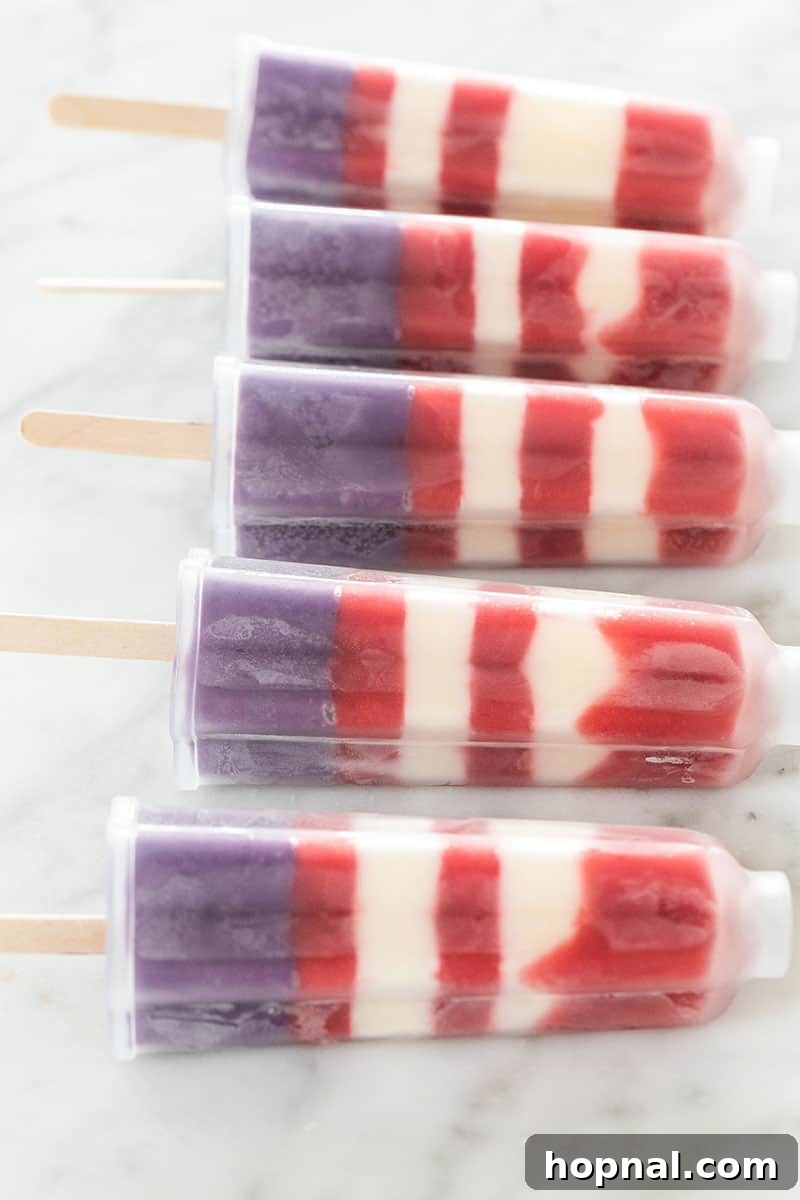 Star-shaped popsicle mold filled with red, white, and blue striped Bomb Pops, ready for a festive occasion.