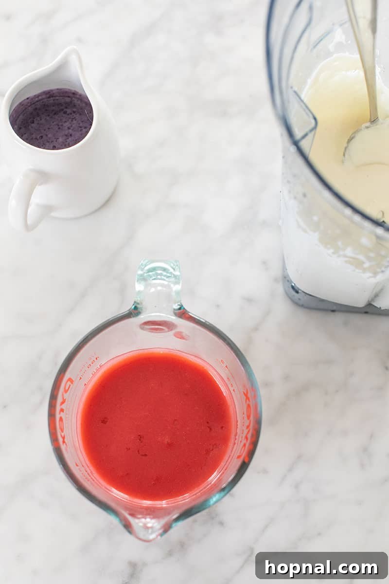 Assortment of fresh ingredients laid out on a table, including strawberries, blueberries, yogurt, milk, and sugar, ready for making Bomb Pop popsicles.