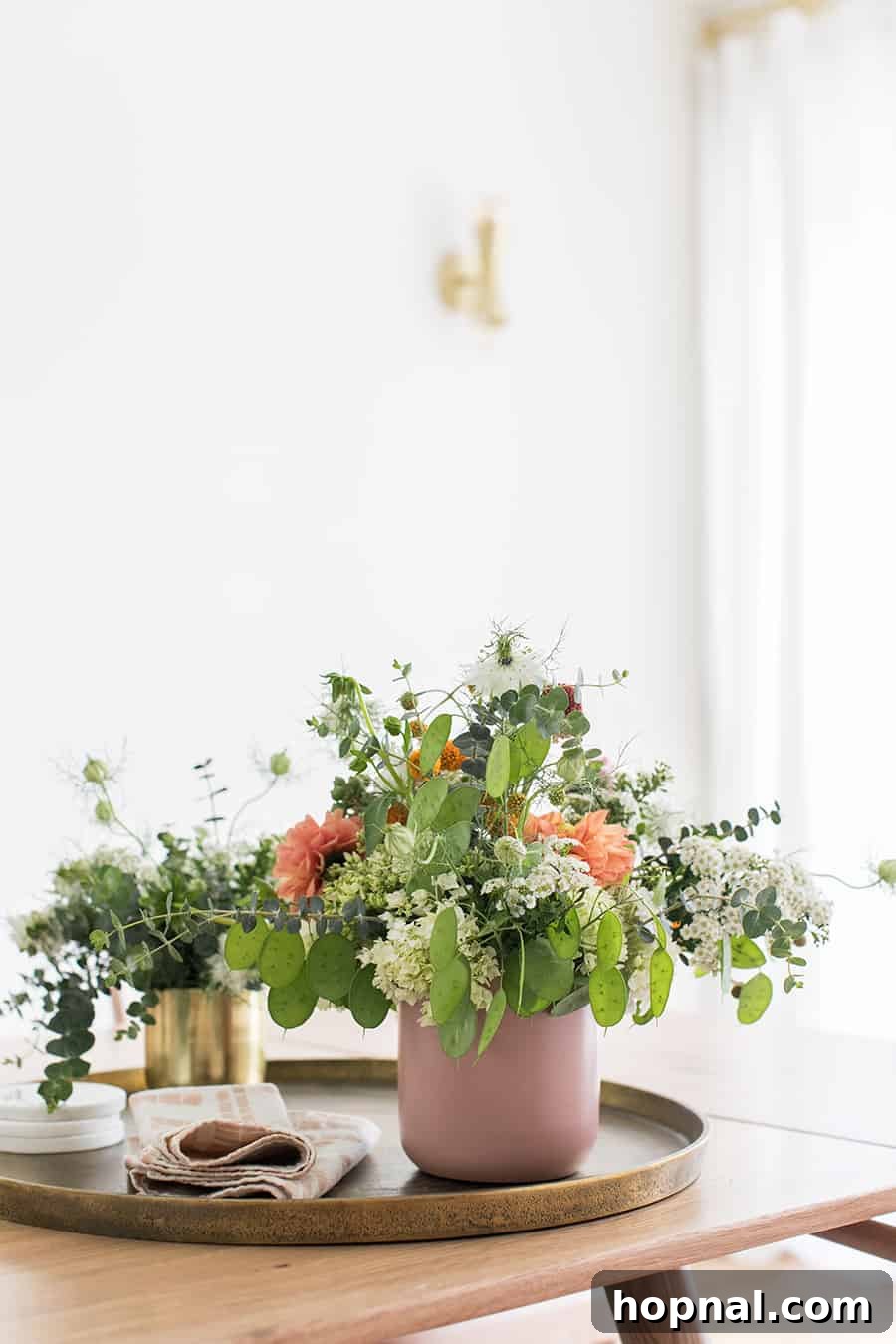 Hygge Your Home, Hygge Your Life 18 A vibrant display of fresh flowers in a pink vase on a rustic wooden table, embodying the fresh and cozy aspects of a year-round hygge lifestyle.