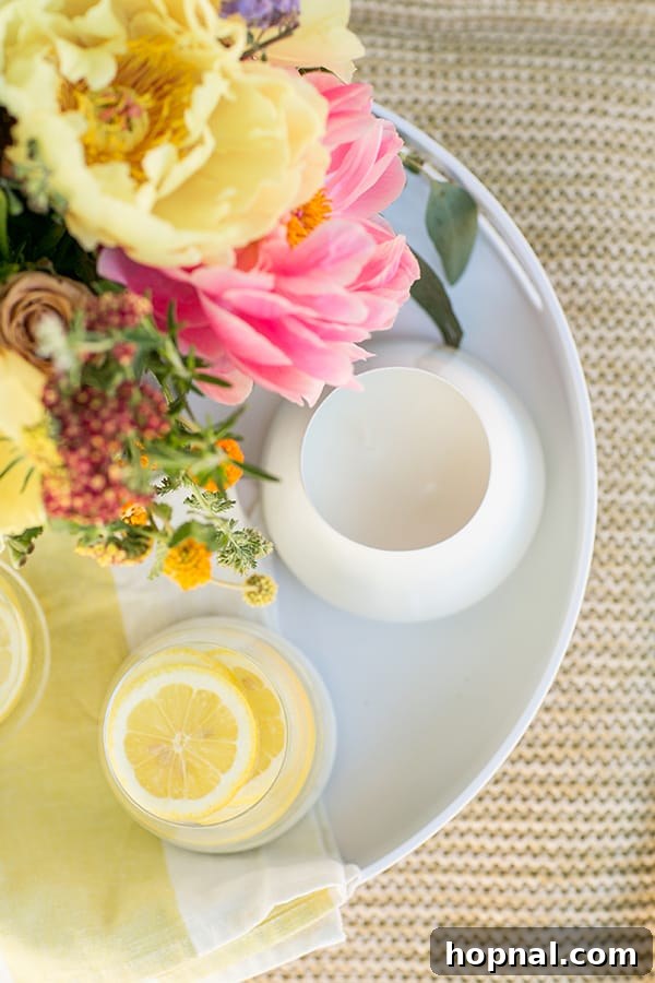 Hygge Your Home, Hygge Your Life 19 Bright lemons arranged with a white candle on a decorative tray, symbolizing the freshness and lightness of spring and summer hygge.