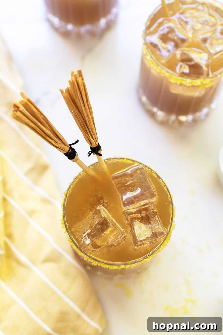 Chilled butterbeer drink inspired by Harry Potter, served attractively in a clear glass mug, ready to be enjoyed.