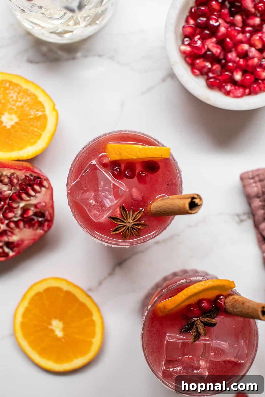 Crimson Spice Margarita 5 Pomegranate margaritas with cinnamon sticks and star anise.
