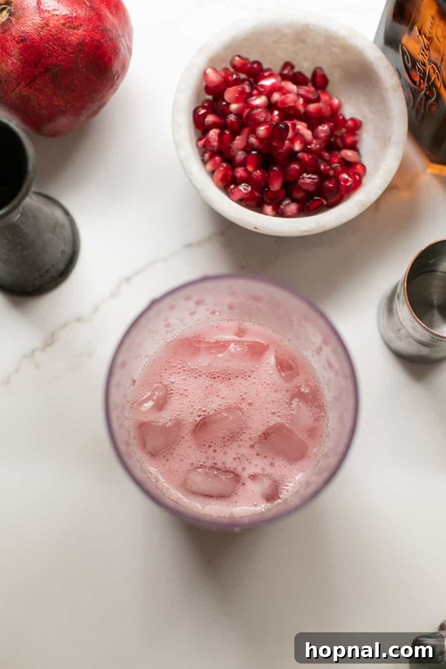 Crimson Spice Margarita 7 Fresh pomegranate cocktail in a cocktail shaker.
