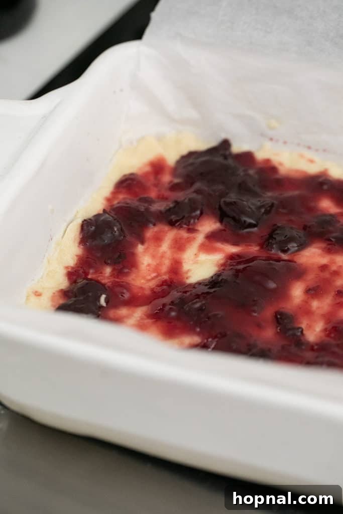 Buttery Shortbread Bars 6 A smooth, even layer of sweet jam spread over the baked shortbread crust.
