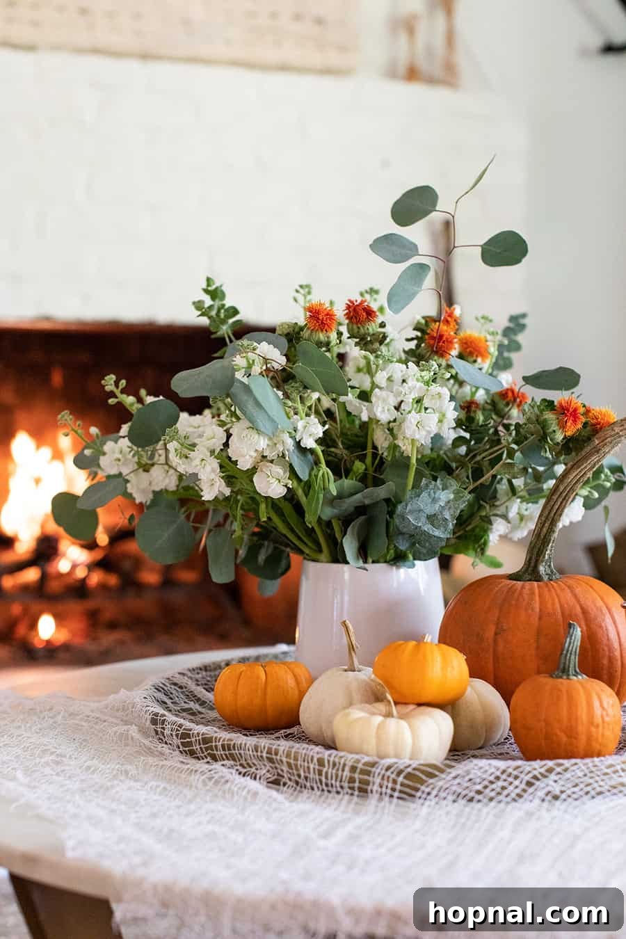Halloween pumpkins and a vase with dark flowers enhancing seasonal decor