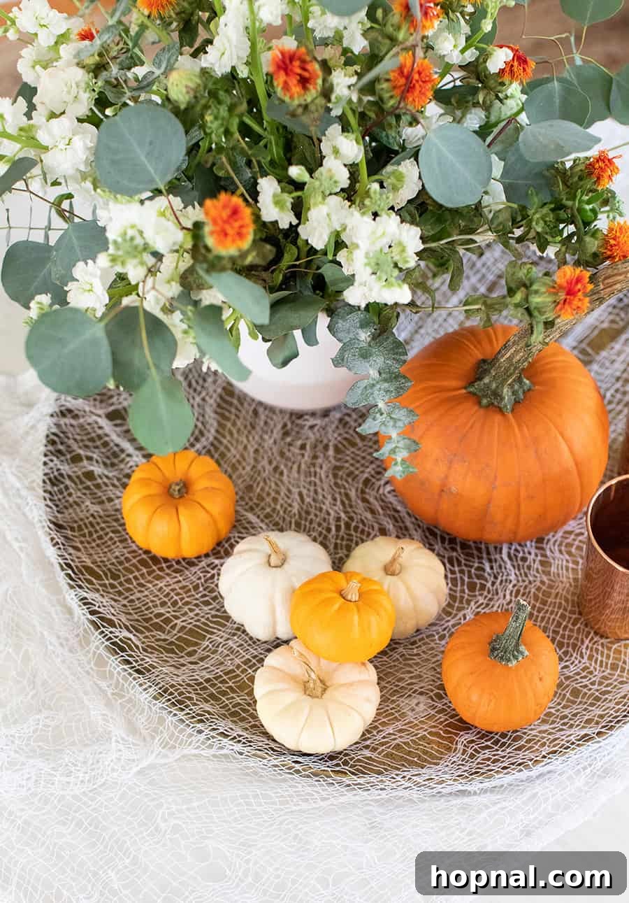 Halloween decorations, pumpkins and Halloween gauze creating a festive mantelpiece