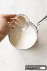Pouring gelatin into warm milk for chocolate panna cotta.