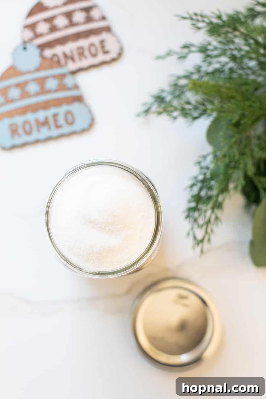 A pristine glass Ball jar filled with perfectly layered sugar, showcasing its purity and readiness for a cookie mix.