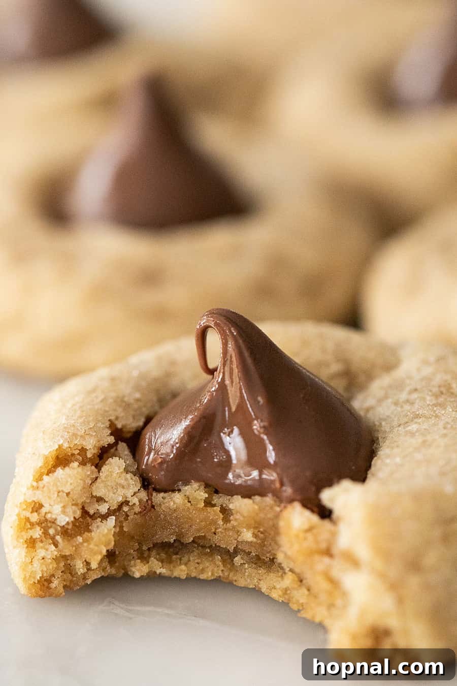 Classic Peanut Butter Blossom Christmas Cookies with a chocolate kiss in the center