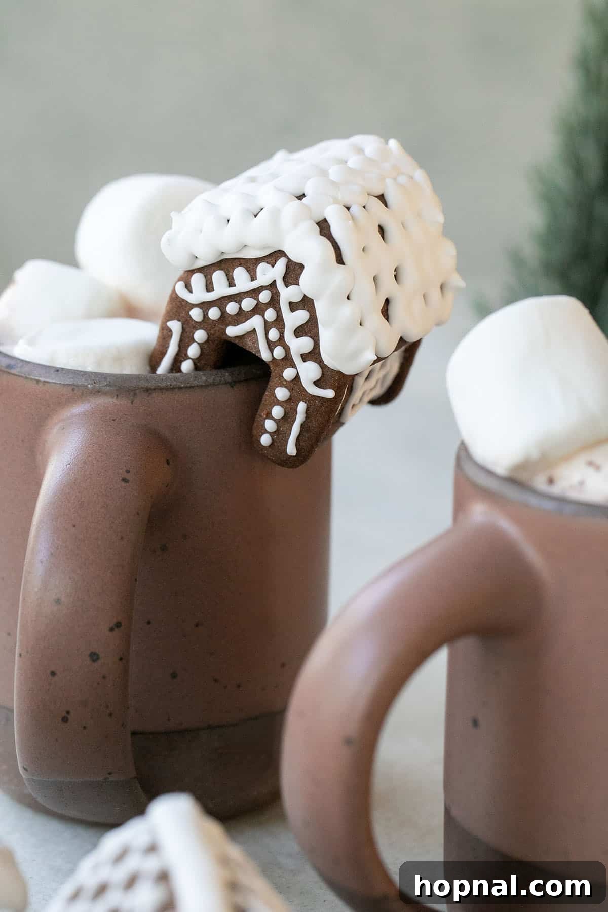 Mini gingerbread house perched on a mug