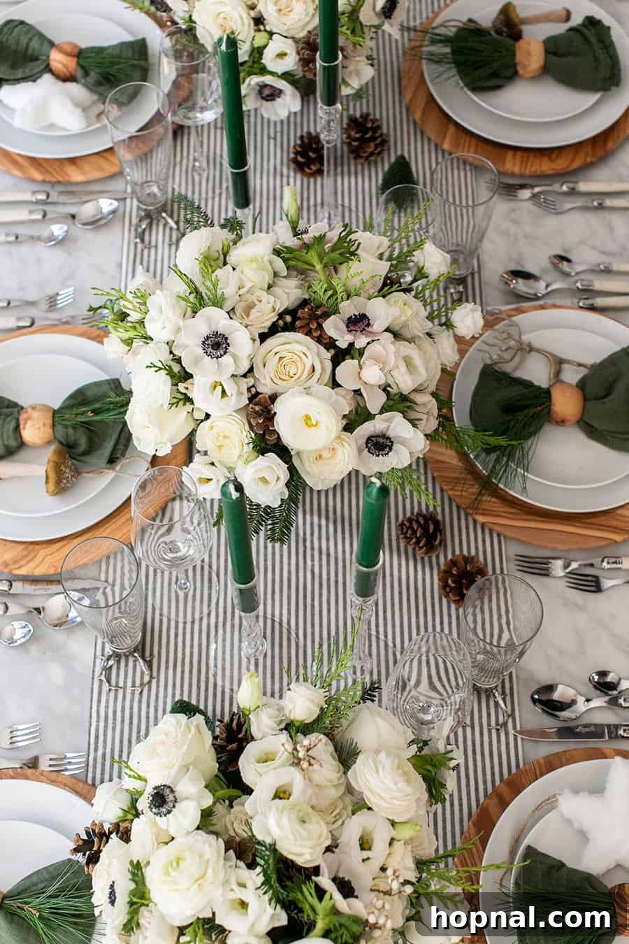 Sparkling Christmas Tablescapes 2 A beautifully arranged Christmas table featuring festive flowers, glowing candles, elegant chargers, and plates, creating a charming holiday atmosphere.