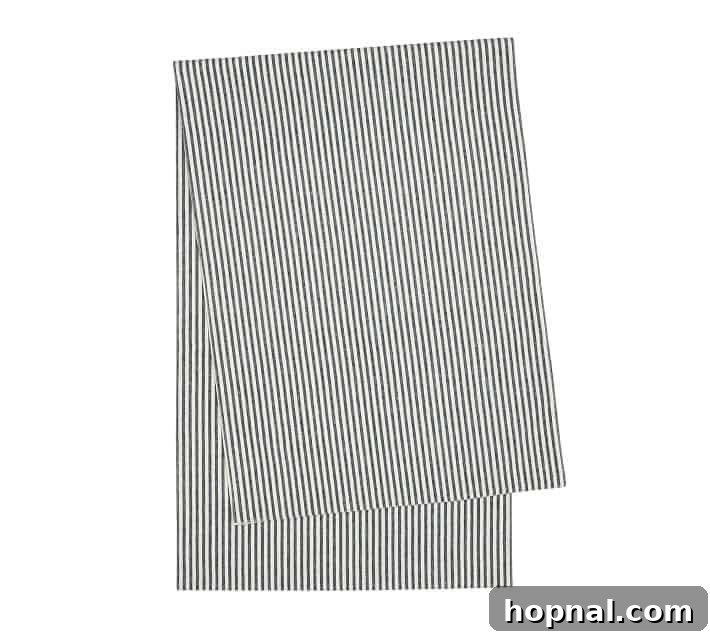 Sparkling Christmas Tablescapes 11 Elegant striped table runner enhancing a festive Christmas table decoration.