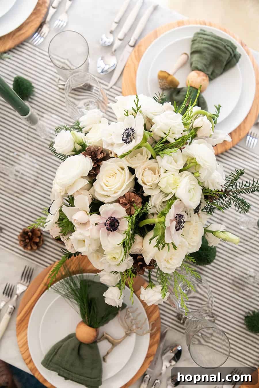 Sparkling Christmas Tablescapes 4 A central Christmas flower arrangement on a table, beautifully complemented by a striped linen table runner, setting a festive mood.