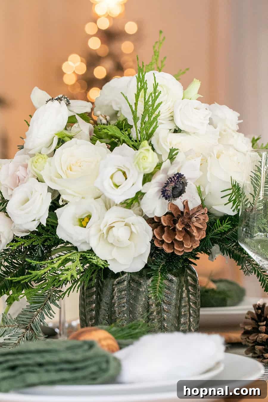 Sparkling Christmas Tablescapes 7 A festive Christmas flower arrangement beautifully displayed in a green vase from Hobby Lobby, enhancing the holiday table decor.