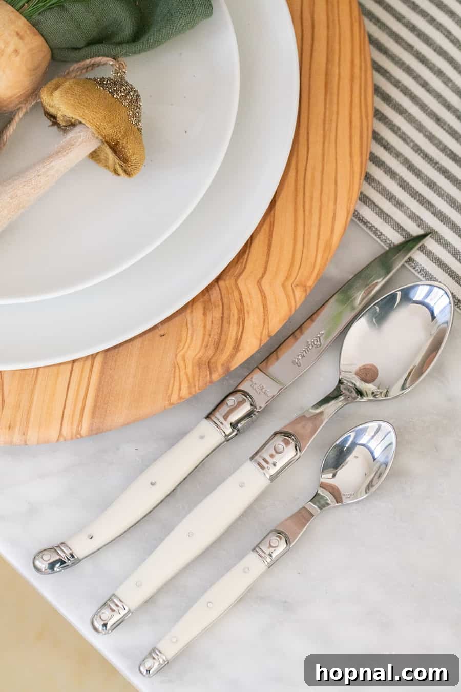 Sparkling Christmas Tablescapes 10 A close-up of the elegant Jean Dubost Laguiole Flatware Set from Williams Sonoma, beautifully arranged on a Christmas table.