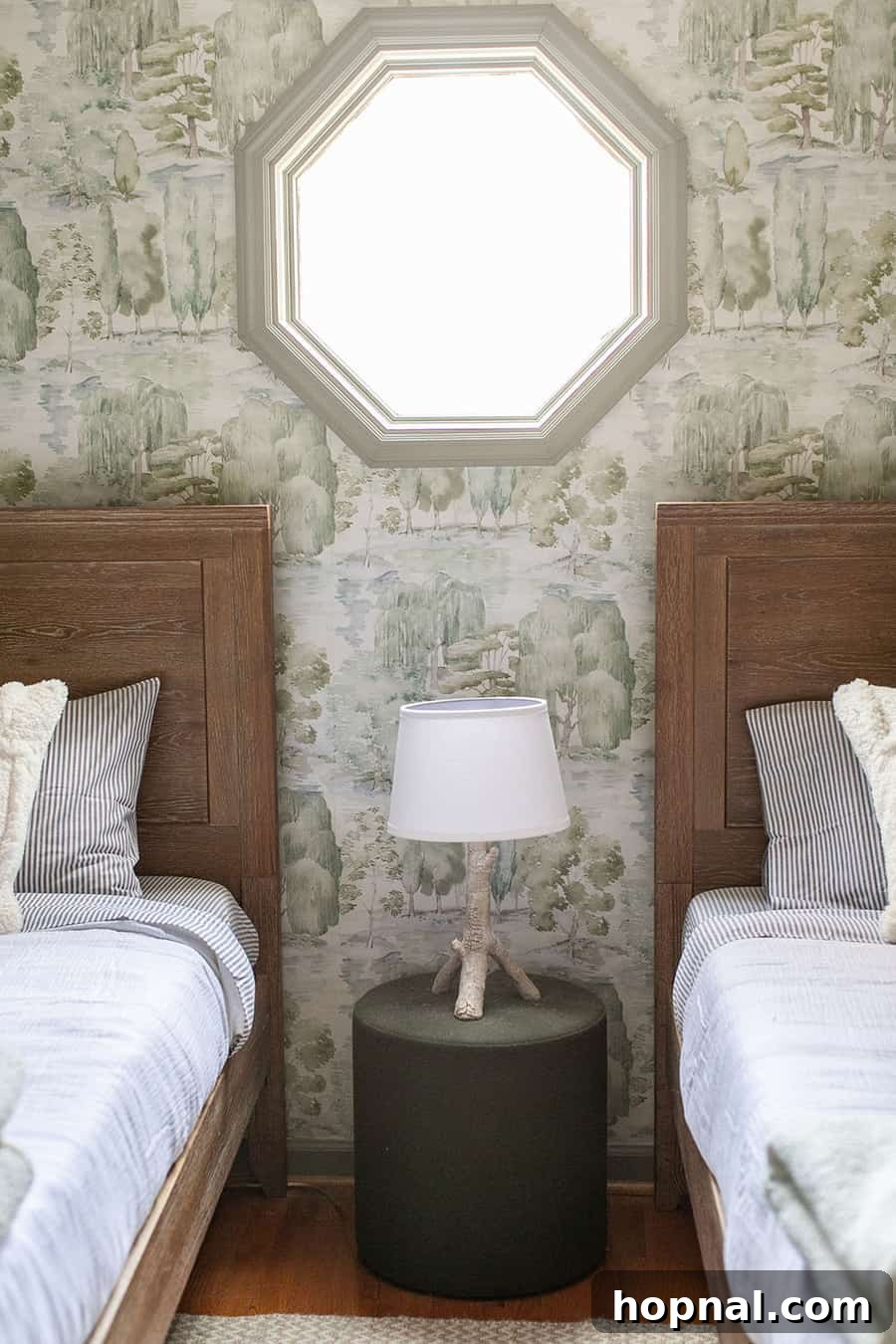 A detailed view of woodsy wallpaper and sturdy wooden beds, showcasing the harmonious blend of nature-inspired design in a kids' cabin bedroom.