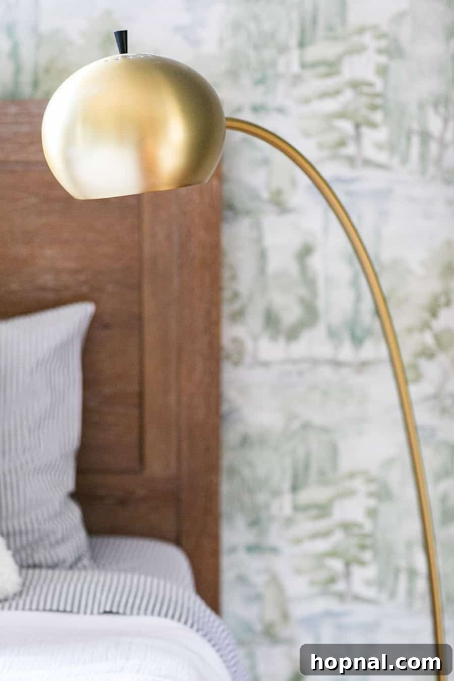 A stylish brass floor lamp from Pottery Barn Teen illuminates a reading nook, adding warmth to a woodsy-themed kids bedroom.