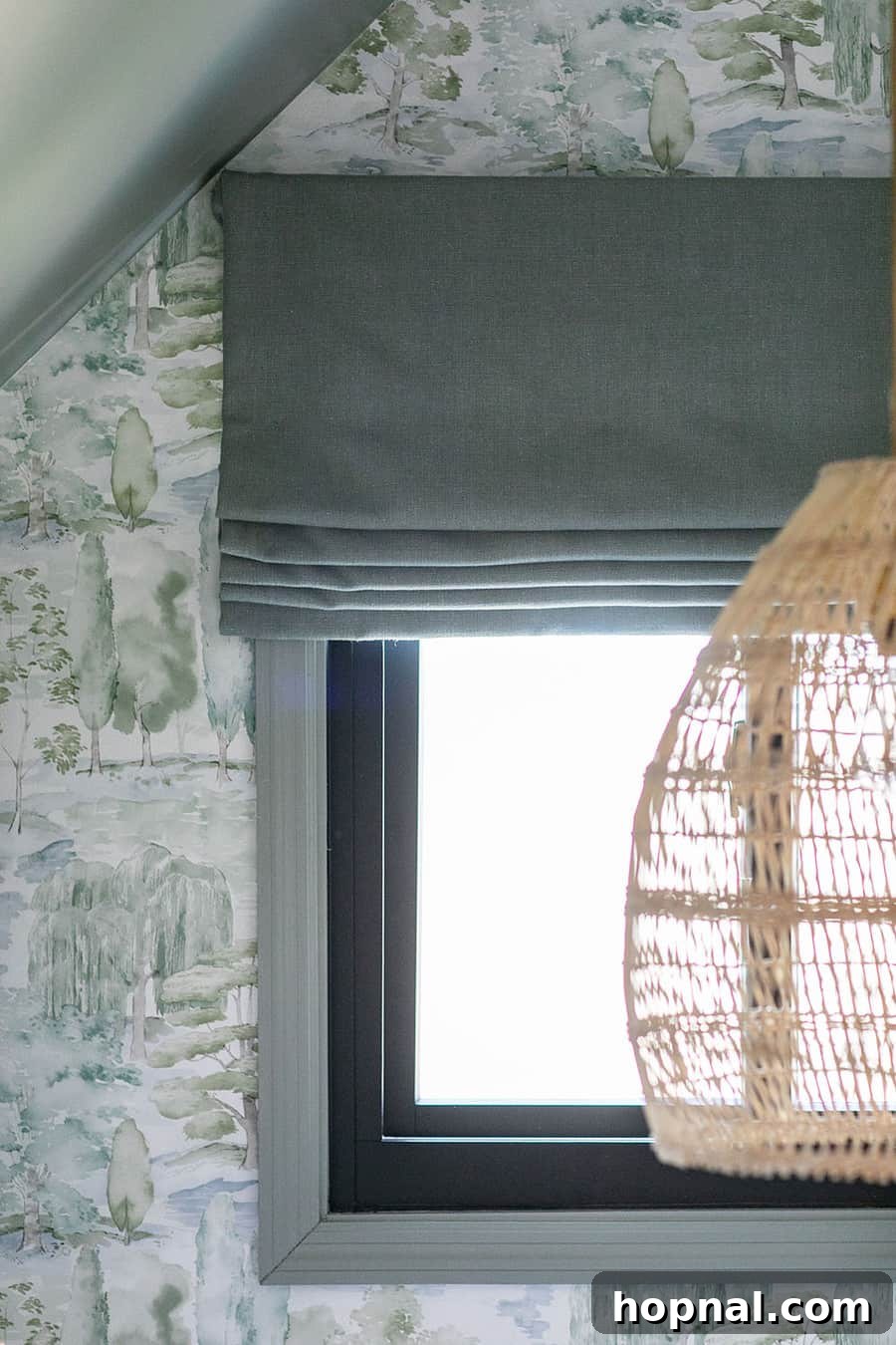 Close-up of a Calico Corners flat Roman shade in a kids' bedroom, showcasing its custom fit and quality fabric within a nature-inspired design.