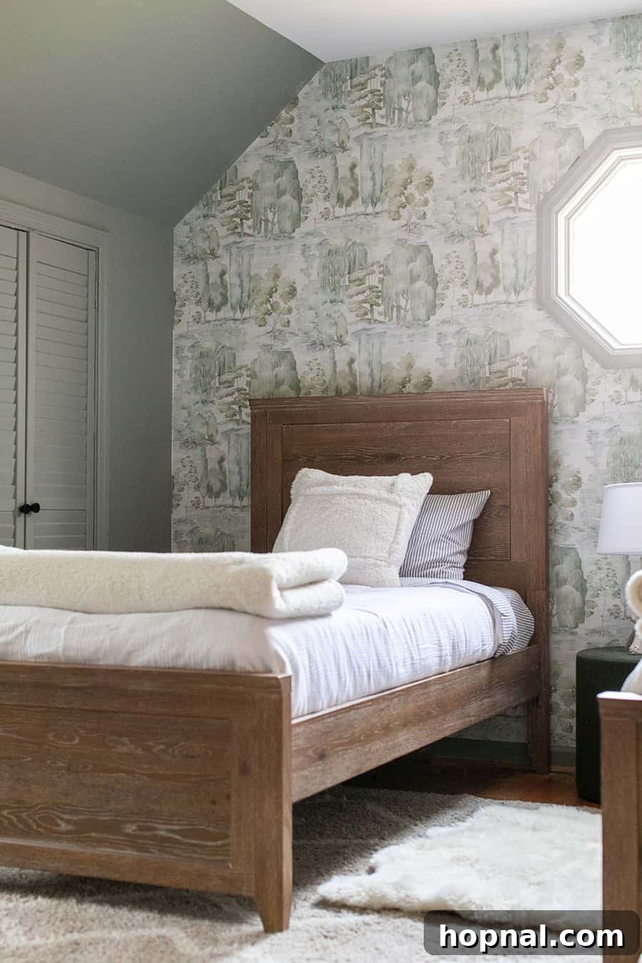 A serene woodsy-themed kids bedroom with custom Roman shades, wooden furniture, and playful elements, embodying a peaceful cabin atmosphere.