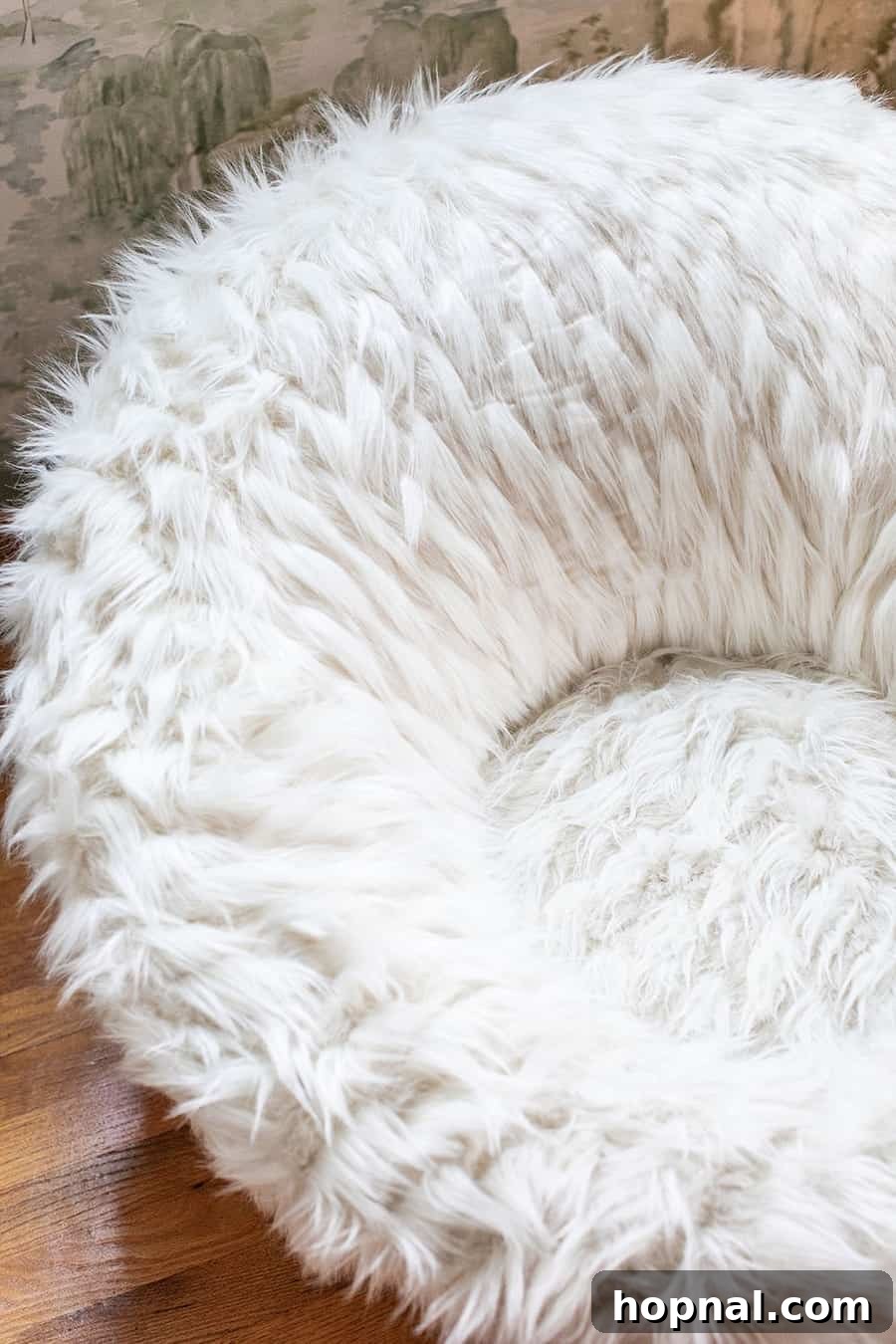 A fuzzy swivel chair, perfect for reading, adds comfort and whimsy to a nature-themed kids bedroom in a Tennessee cabin.