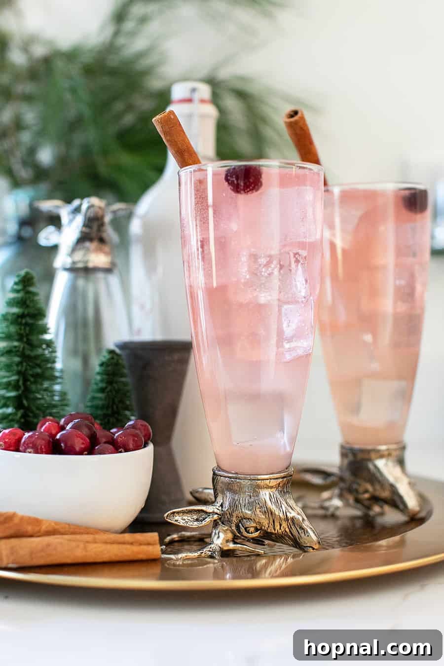 Rudolph Collins cocktail in tall reindeer glasses with festive garnishes.