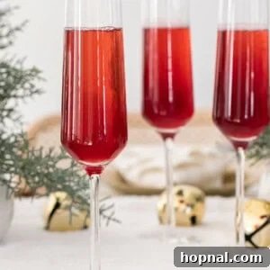 Vibrant red mimosa in a flute glass.
