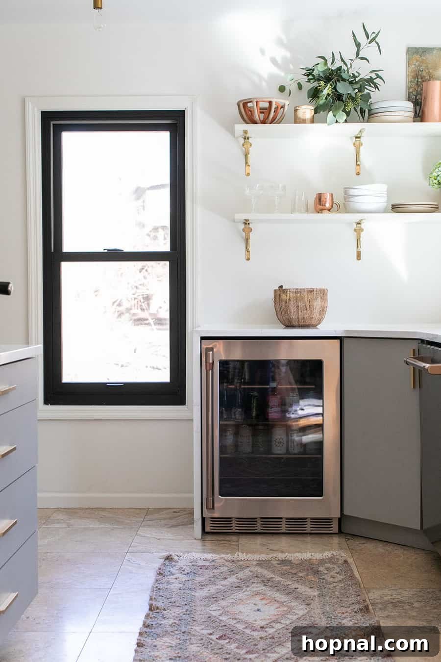 Tiny Kitchen Big Impact 11 GE Cafe Appliances beverage center integrated with white quartz countertops