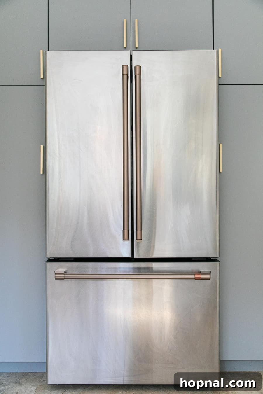 Tiny Kitchen Big Impact 13 Cafe Appliances stainless steel refrigerator with brushed brass handles in a modern kitchen